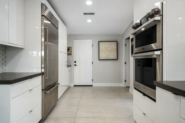 a bed room with a bed tv and a large window