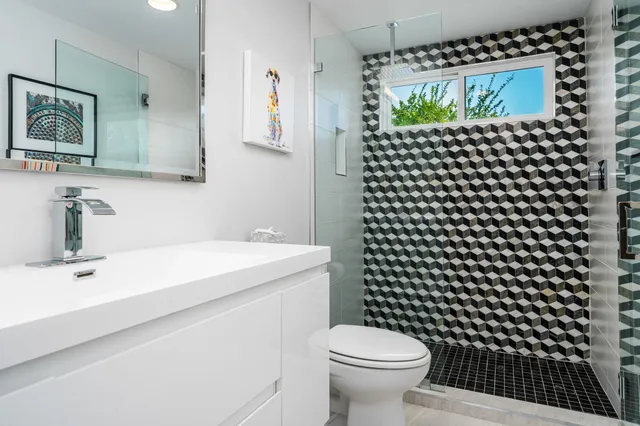 a view of a patio with a table and chairs under an umbrella