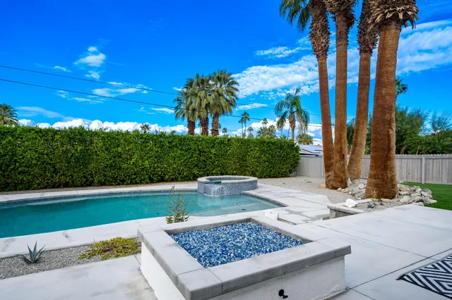 a view of outdoor space with swimming pool and furniture