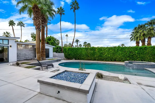 a swimming pool with outdoor seating yard and barbeque oven