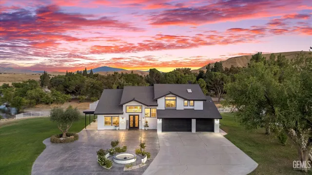 a front view of a house with a garden and pathway