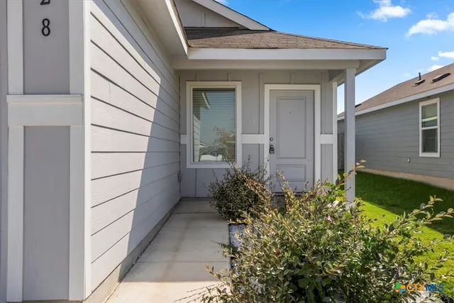 a view of a pathway besides a house