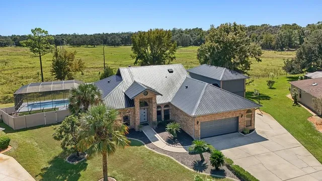 an aerial view of a house with a ocean view