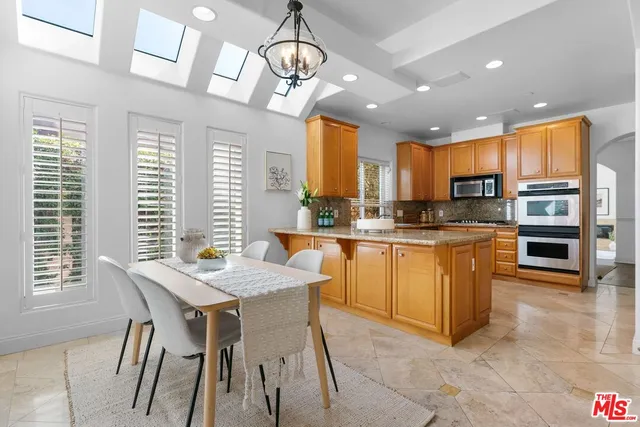 a kitchen with stainless steel appliances granite countertop counter space a sink and cabinets