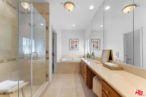 a bathroom with a tub sink and mirror
