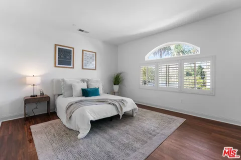a spacious bedroom with a bed and a window
