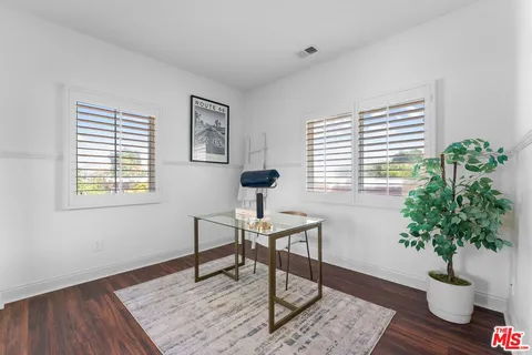 a workspace with furniture and a potted plant