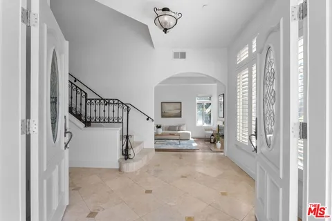 a view of entryway and hall with a front door