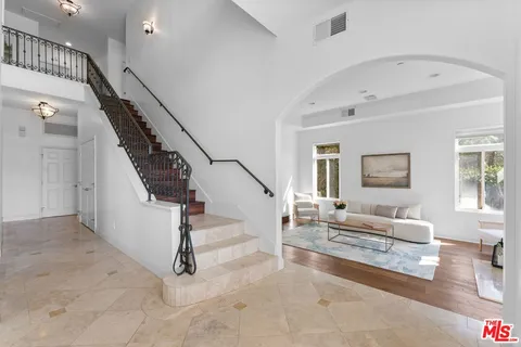 a living room with stairs and a couch