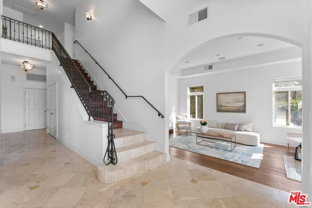 a living room with stairs and a couch