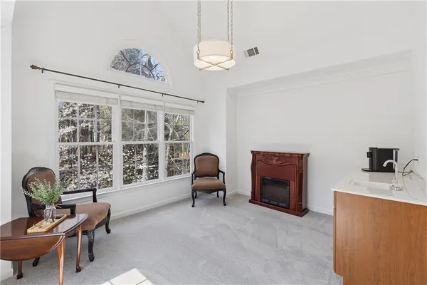 a living room with fireplace furniture and a flat screen tv
