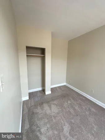 a view of an empty room and closet area