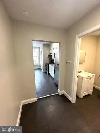 a view of a room with wooden floor and a cabinet