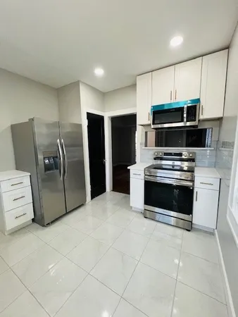 a kitchen with stainless steel appliances a stove a microwave and a refrigerator