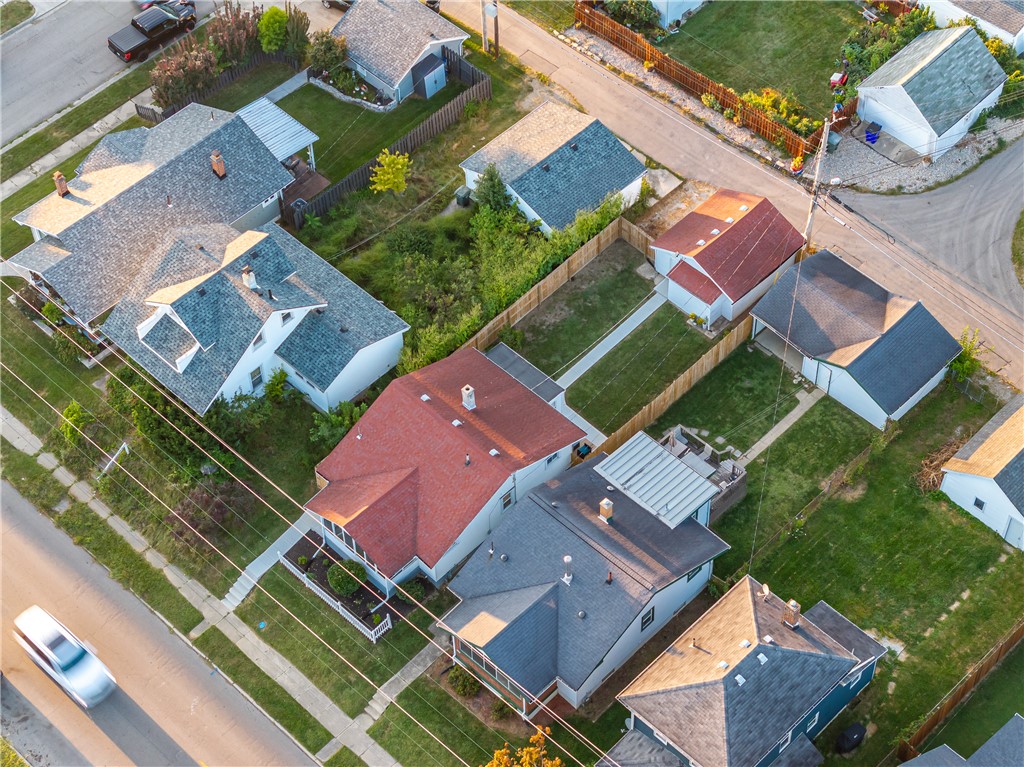 1915 Patterson Road Dayton, OH 45420 - Photo 48 of 48 An aerial view captures the vibrant neighborhood, featuring diverse homes and lush yards under a clear sky.