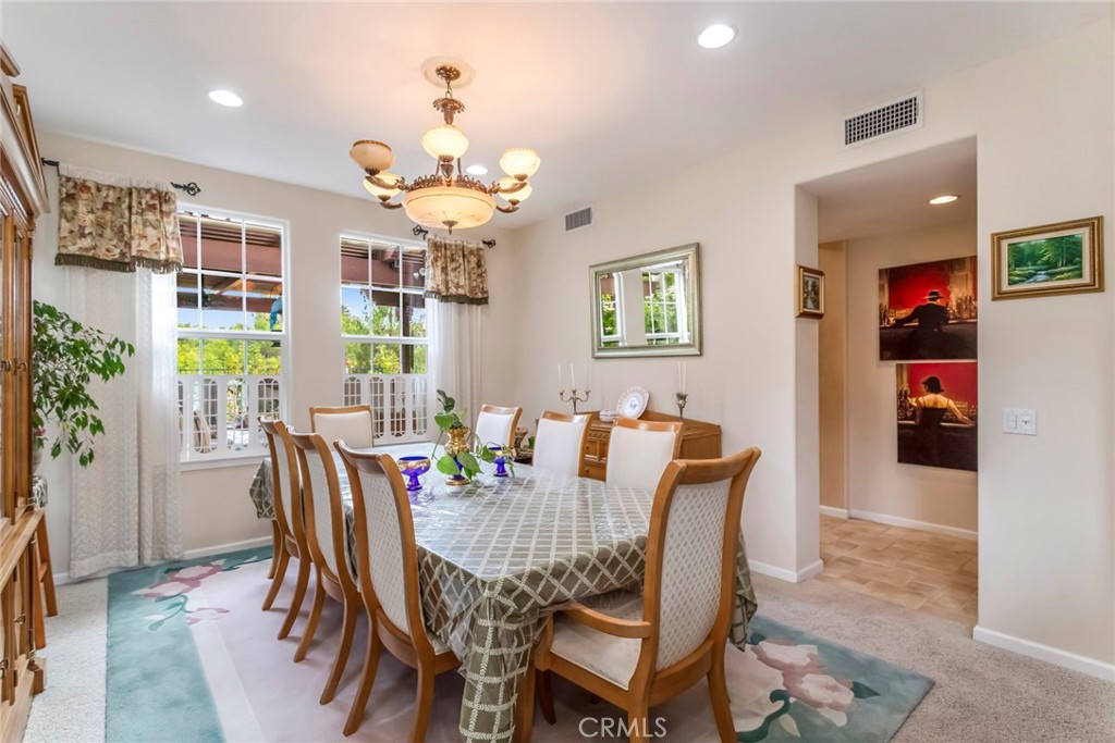 25808 Tennyson Lane Stevenson Ranch, CA 91381 - Photo 13 of 74 a view of a dining room with furniture and chandelier