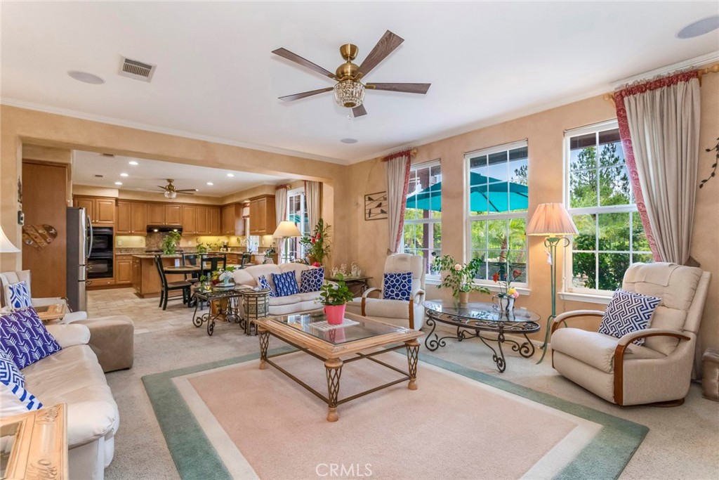 25808 Tennyson Lane Stevenson Ranch, CA 91381 - Photo 22 of 74 a living room with furniture ceiling fan and a large window
