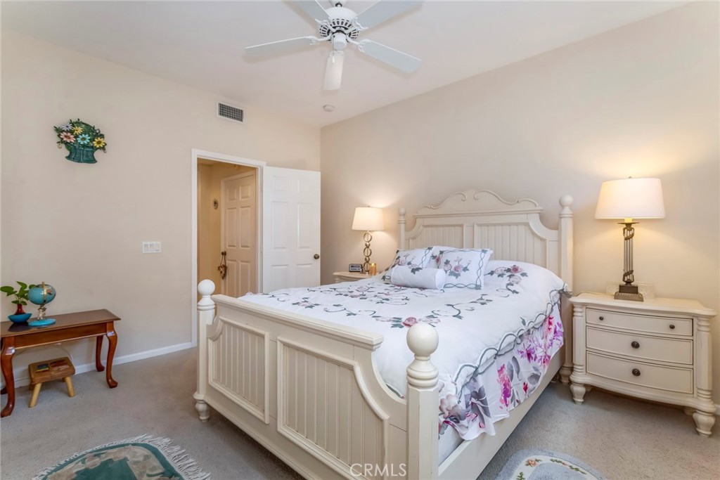 25808 Tennyson Lane Stevenson Ranch, CA 91381 - Photo 25 of 74 a bedroom with a bed and a chandelier