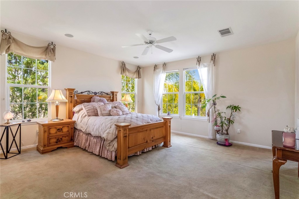 25808 Tennyson Lane Stevenson Ranch, CA 91381 - Photo 29 of 74 a living room with a bed and a chandelier