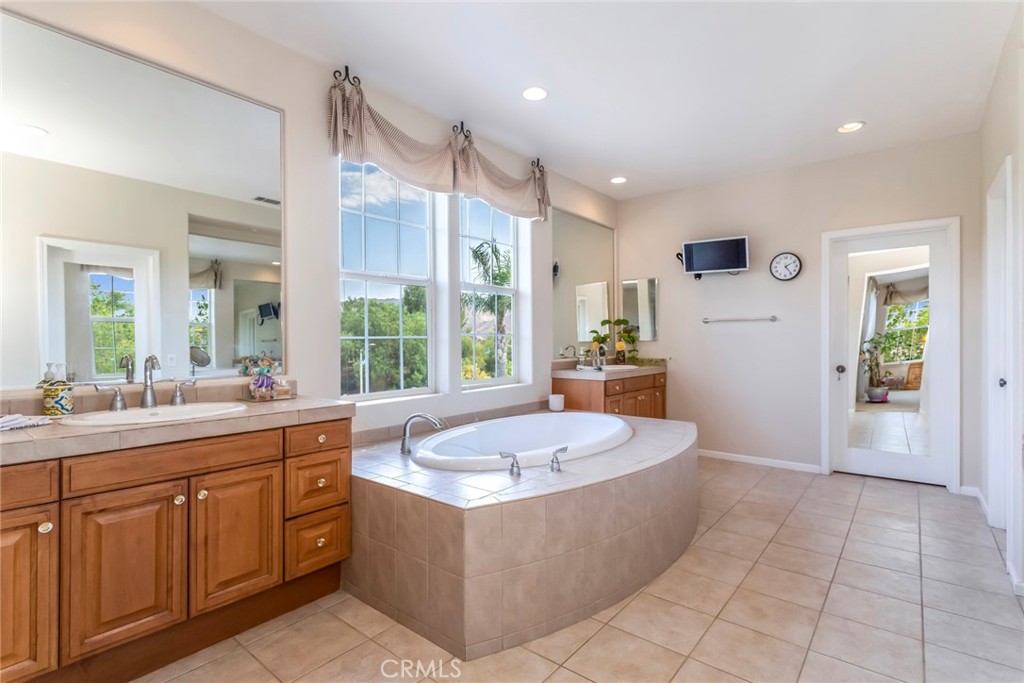 25808 Tennyson Lane Stevenson Ranch, CA 91381 - Photo 33 of 74 a large spacious bathroom with a large tub shower and sink