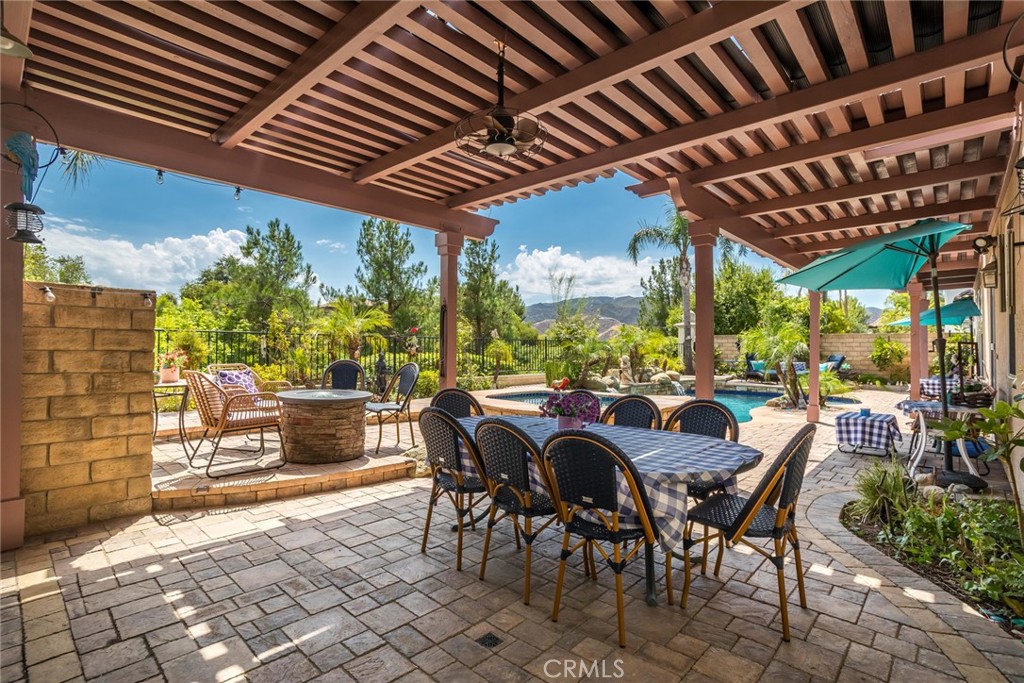 25808 Tennyson Lane Stevenson Ranch, CA 91381 - Photo 44 of 74 a view of a patio with table and chairs and potted plants