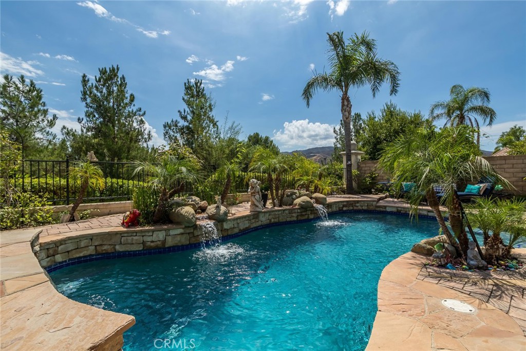 25808 Tennyson Lane Stevenson Ranch, CA 91381 - Photo 46 of 74 a view of a swimming pool with a patio and a garden