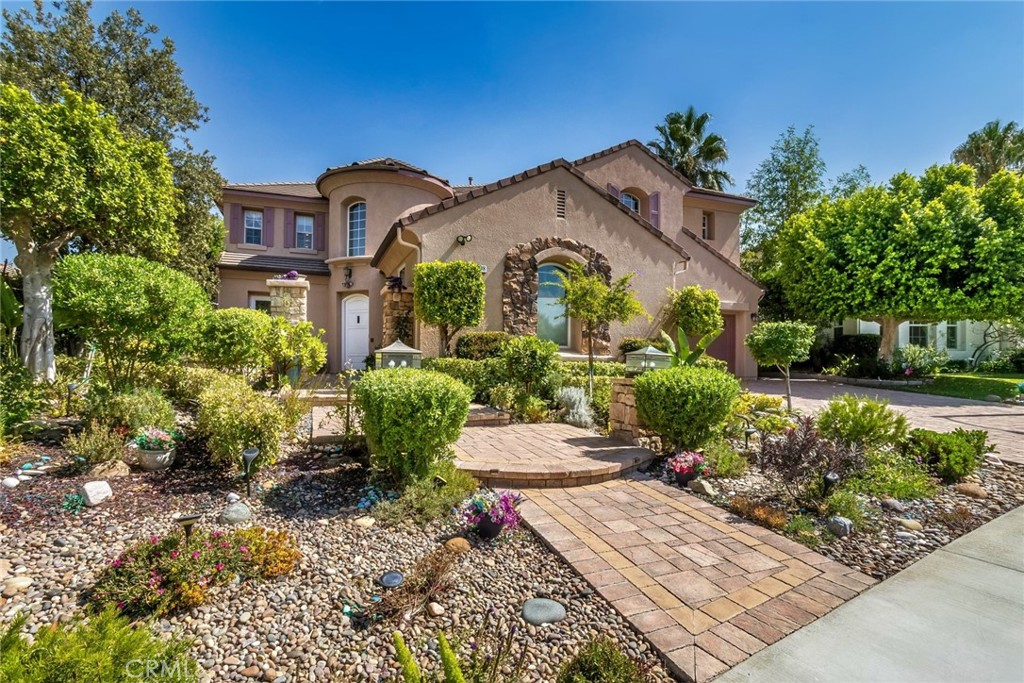 25808 Tennyson Lane Stevenson Ranch, CA 91381 - Photo 6 of 74 a front view of a house with a yard and a garden