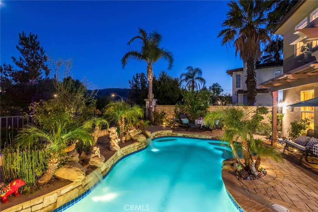 25808 Tennyson Lane Stevenson Ranch, CA 91381 - Photo 71 of 74 a view of a swimming pool with a table and chairs