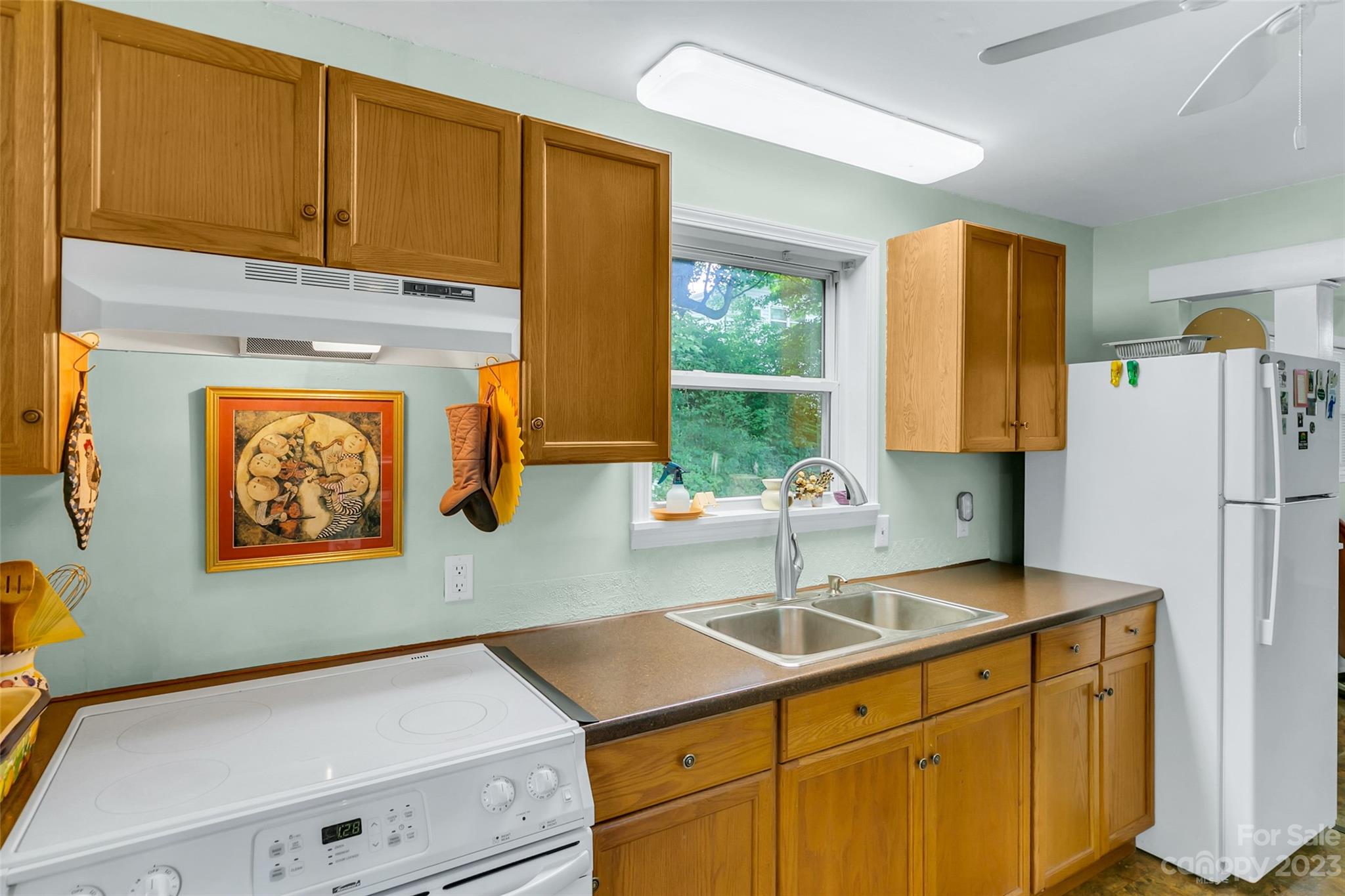 83 East View Street Marion, NC 28752 - Photo 9 of 24 a kitchen with a sink cabinets and a refrigerator