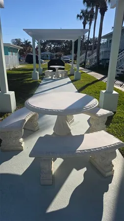 a view of a patio with couches table and chairs and potted plants