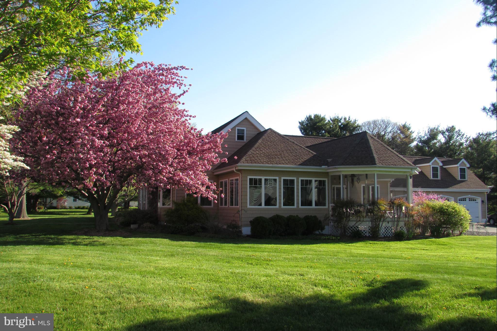 201 Greenwood Creek Road Queenstown, MD 21658 - Photo 1 of 25 a front view of a house with garden