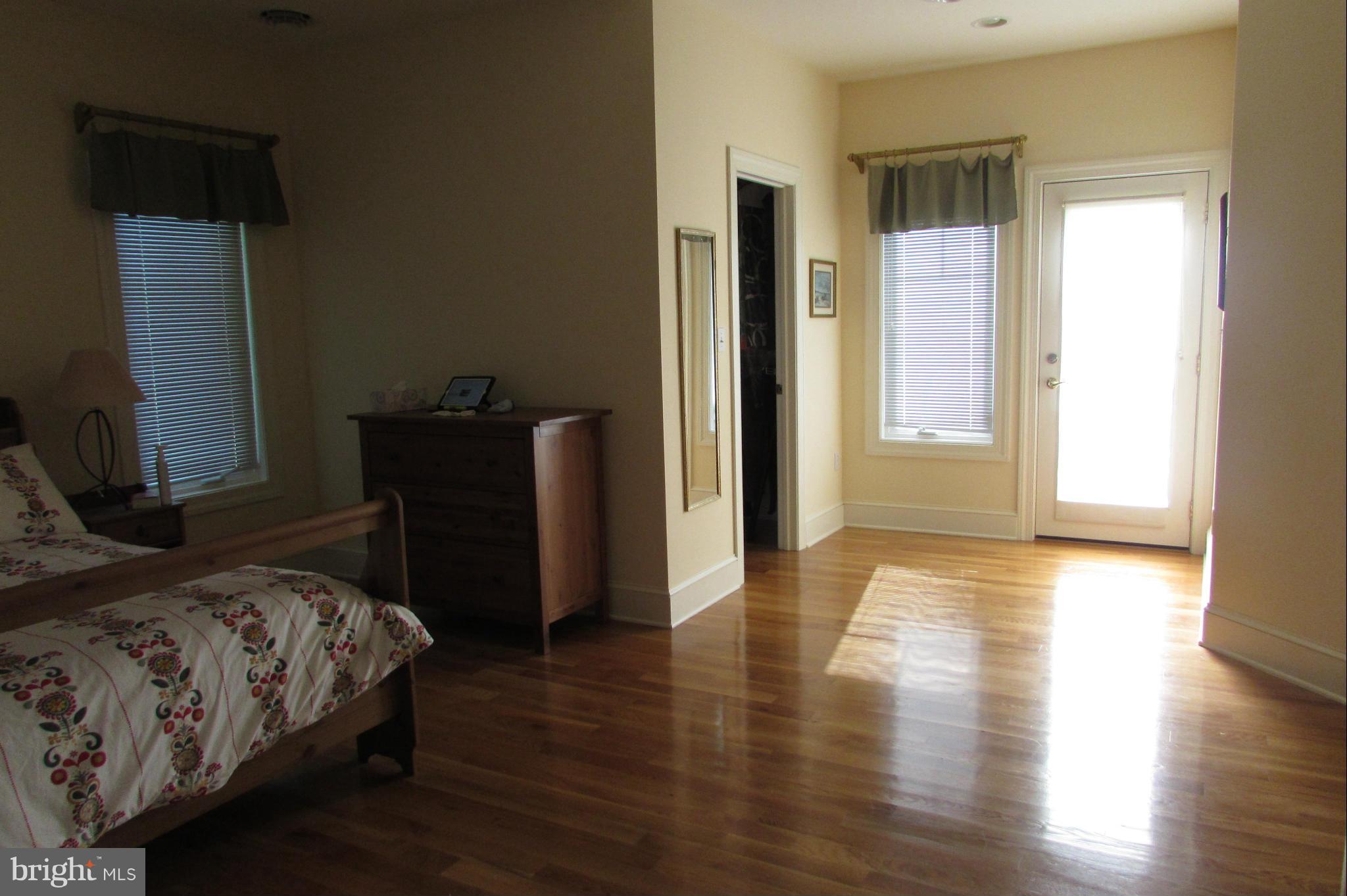 201 Greenwood Creek Road Queenstown, MD 21658 - Photo 12 of 25 a bedroom with a bed and wooden floor