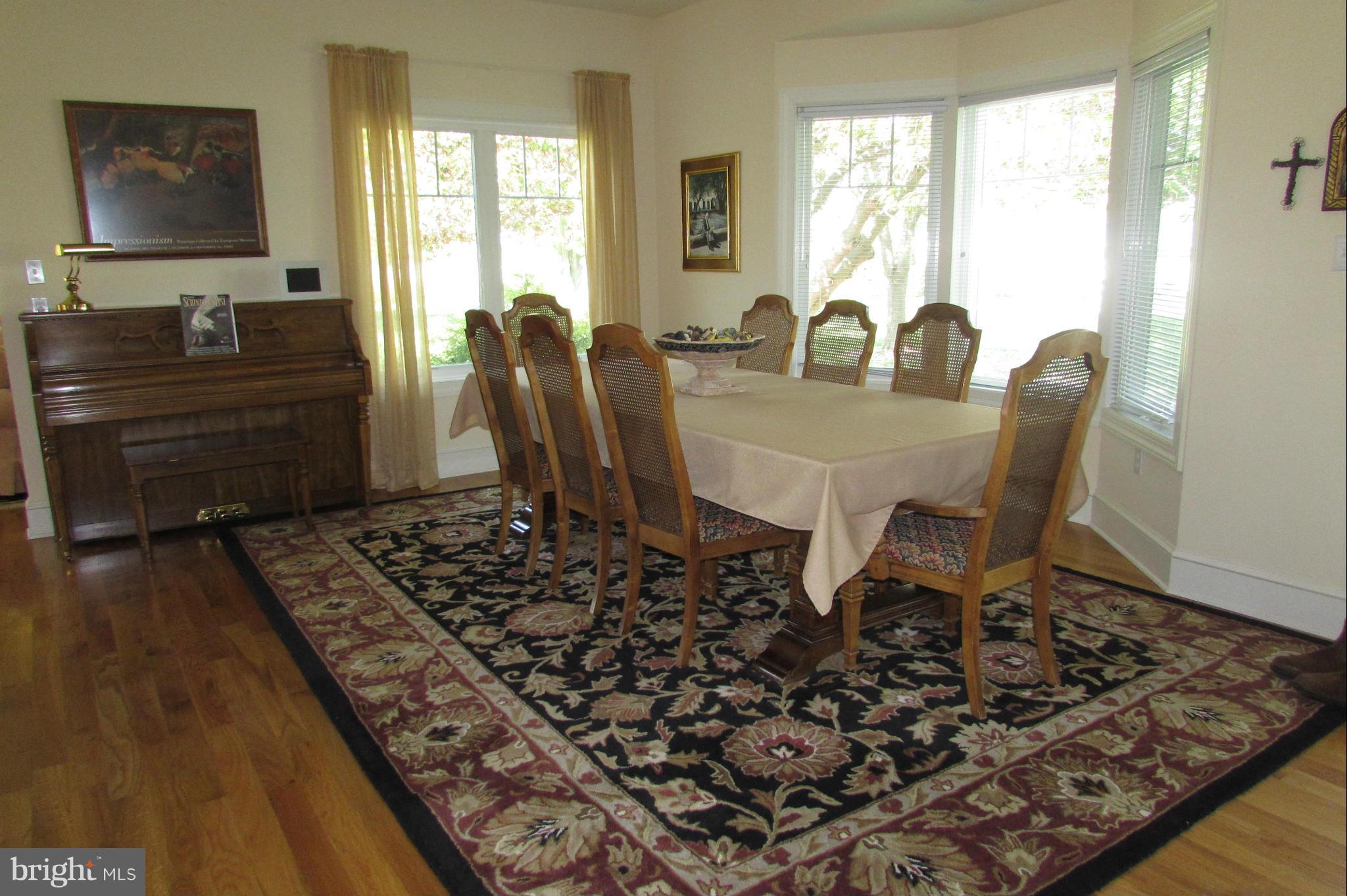 201 Greenwood Creek Road Queenstown, MD 21658 - Photo 14 of 25 a view of a dining room with furniture window and wooden floor