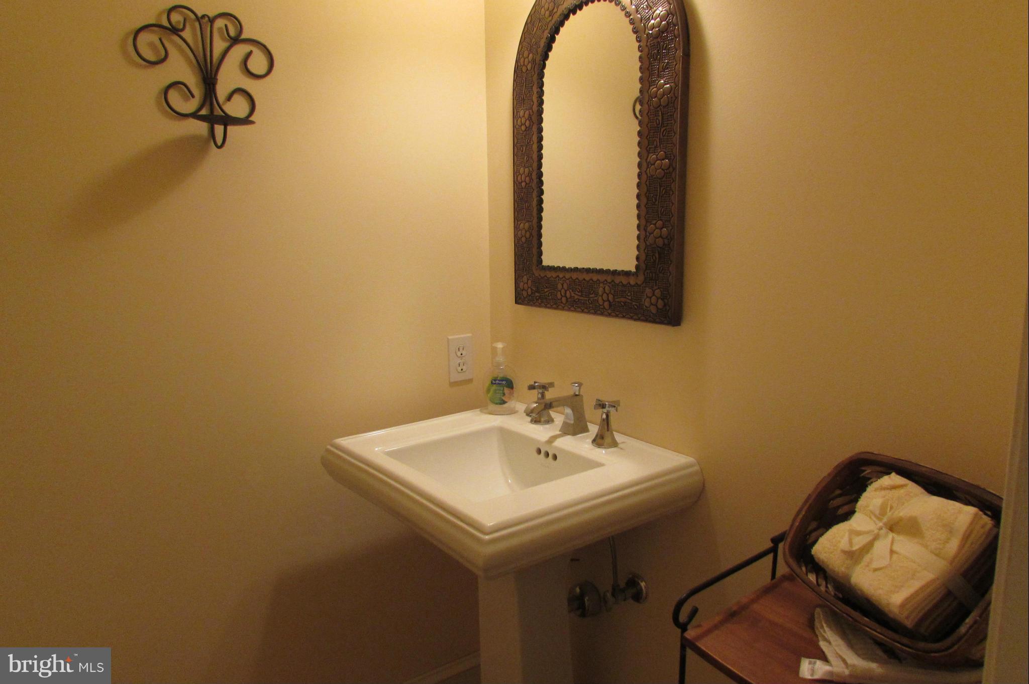 201 Greenwood Creek Road Queenstown, MD 21658 - Photo 15 of 25 a bathroom with a sink and a mirror