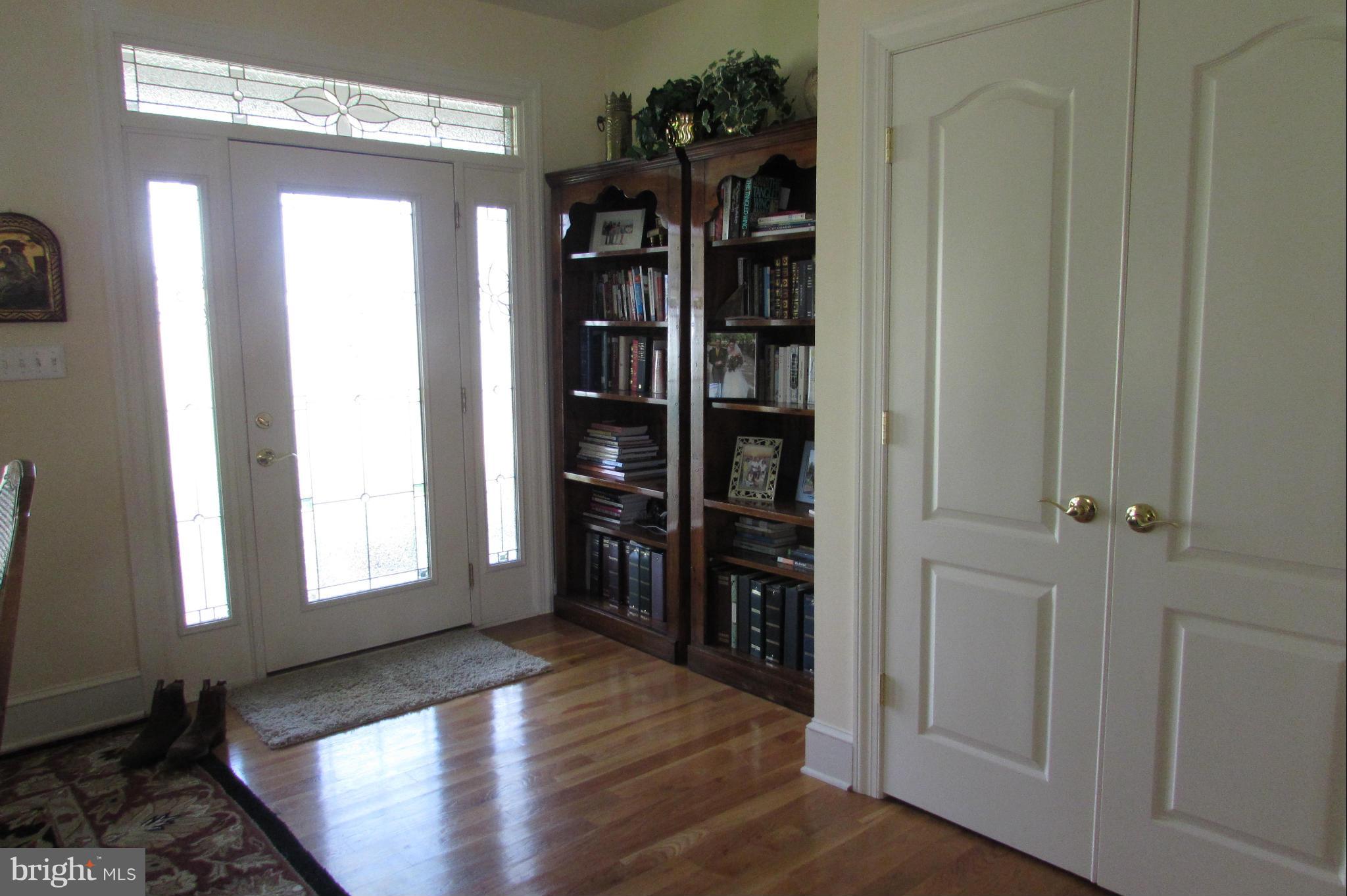201 Greenwood Creek Road Queenstown, MD 21658 - Photo 16 of 25 a view of a hallway with wooden floor and windows