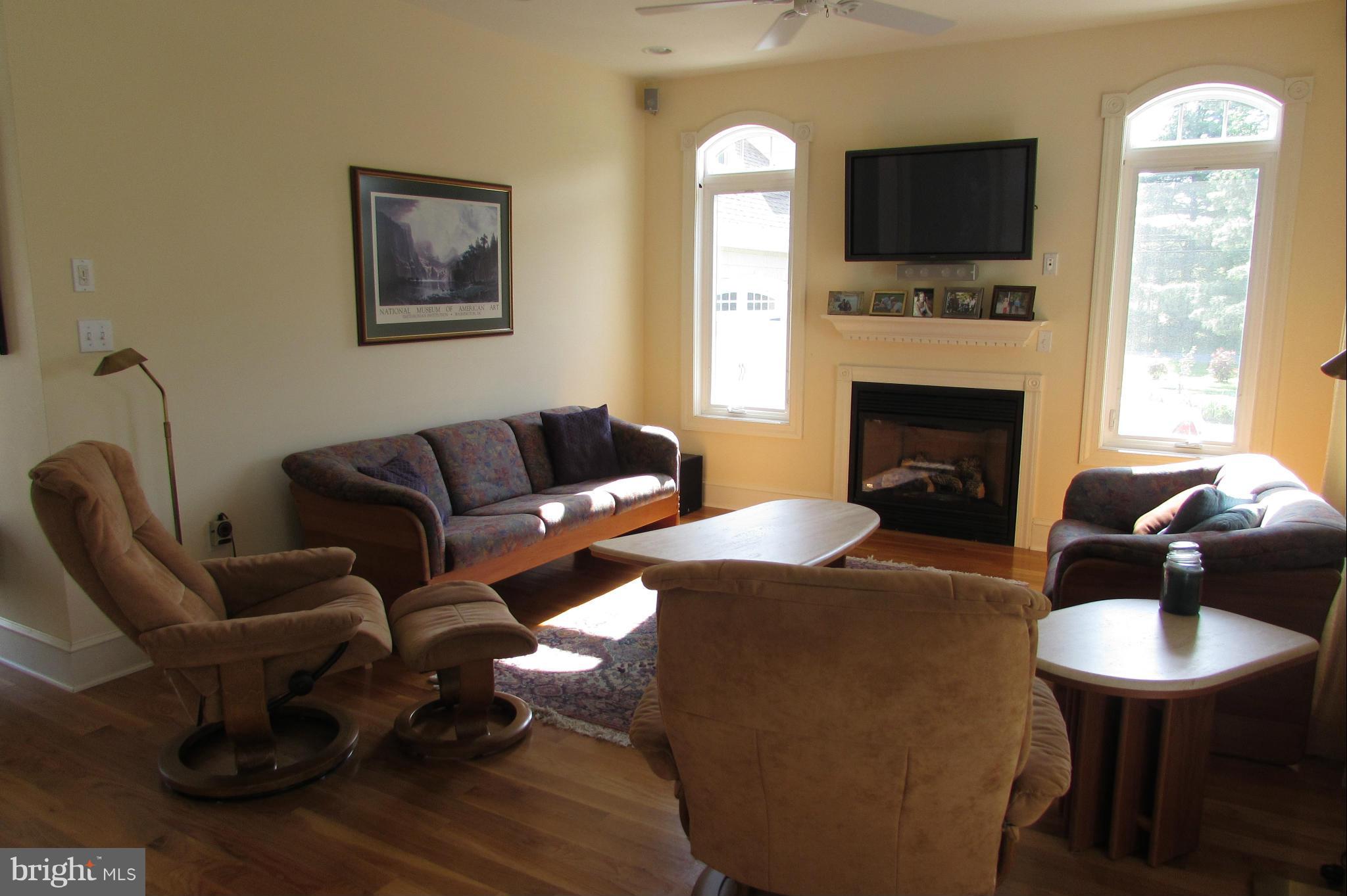 201 Greenwood Creek Road Queenstown, MD 21658 - Photo 18 of 25 a living room with furniture a flat screen tv and a fireplace