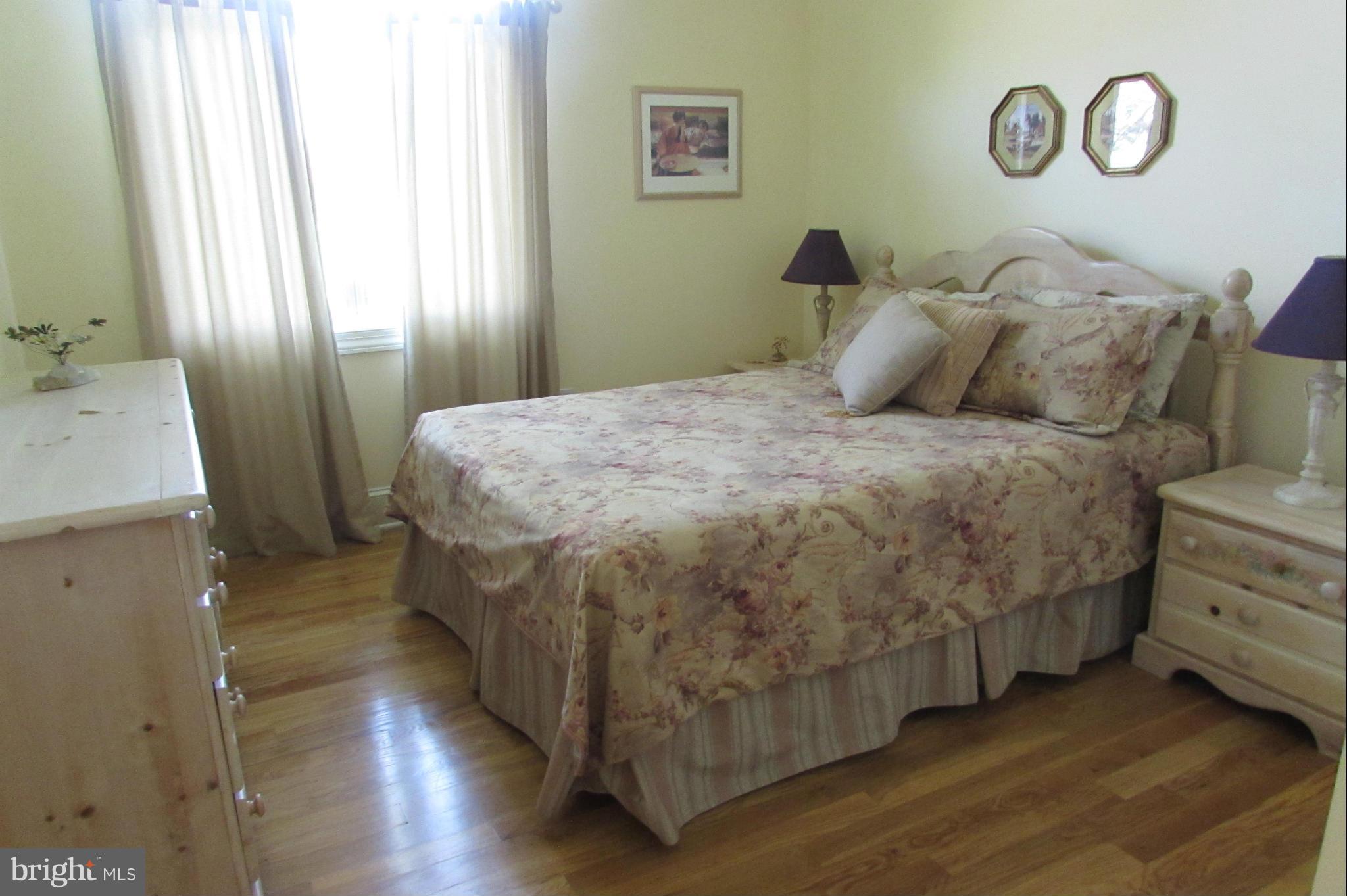 201 Greenwood Creek Road Queenstown, MD 21658 - Photo 20 of 25 a spacious bedroom with a bed and a window
