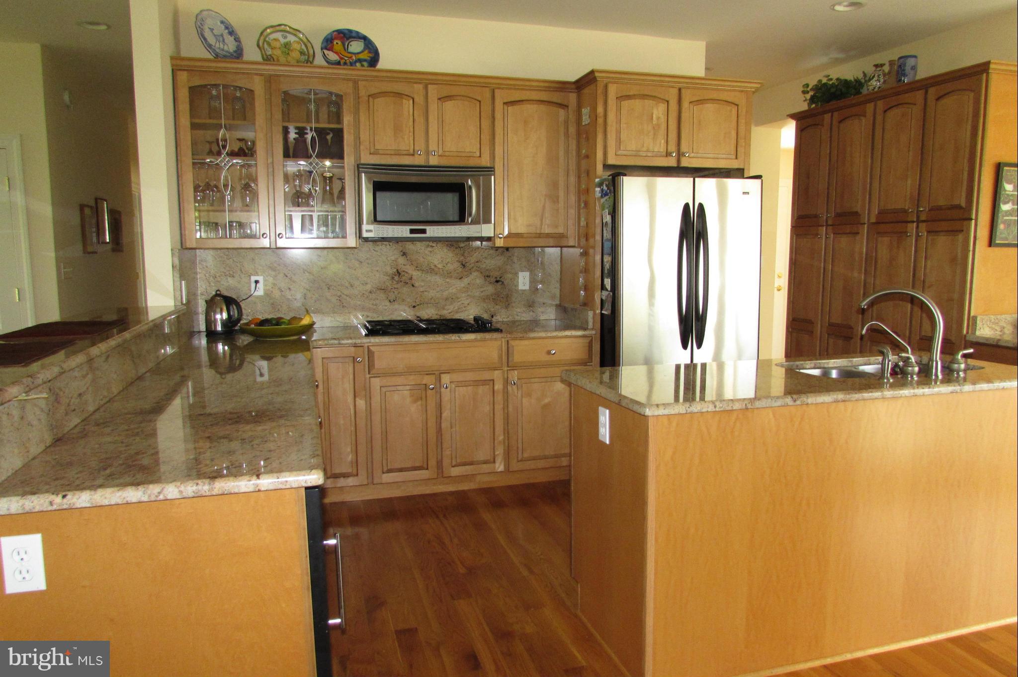 201 Greenwood Creek Road Queenstown, MD 21658 - Photo 6 of 25 a kitchen with kitchen island a sink appliances and cabinets