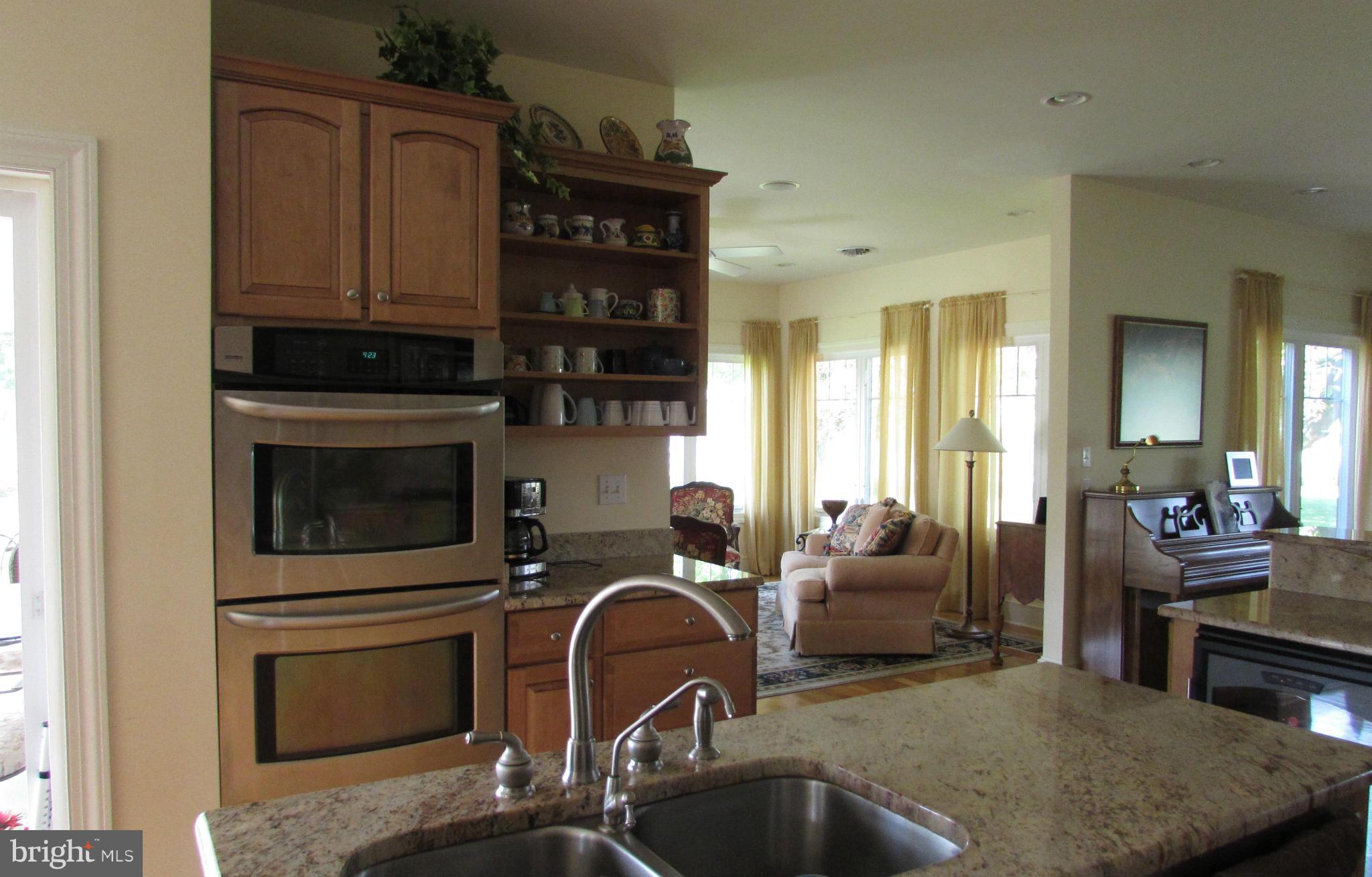 201 Greenwood Creek Road Queenstown, MD 21658 - Photo 8 of 25 a kitchen with stainless steel appliances granite countertop a stove and a sink