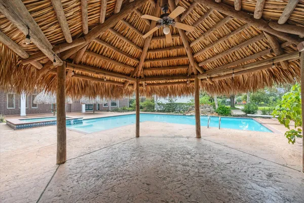 a view of a hallway with windows and flower pot