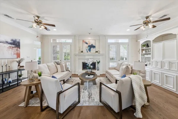 a living room with furniture a couch and a chandelier