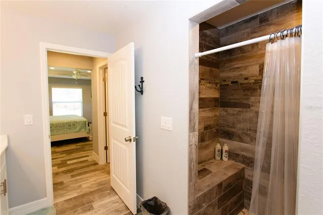 a bathroom with a glass door shower and a sink