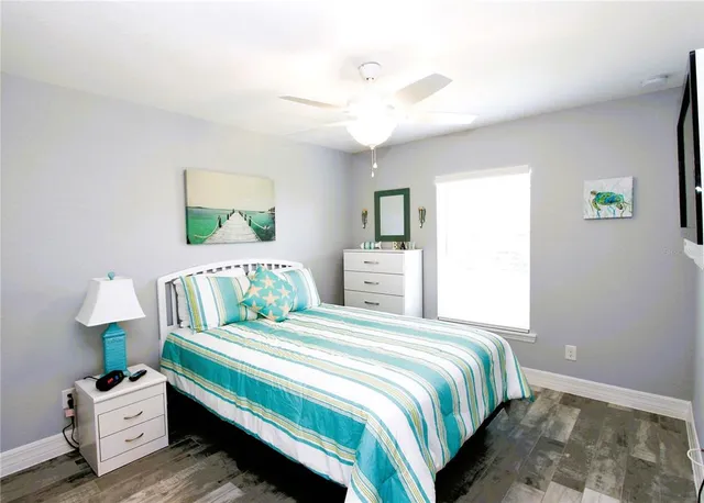 a bedroom with a bed table and a window