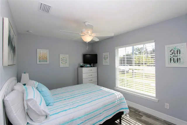 a bedroom with a large bed and a tv