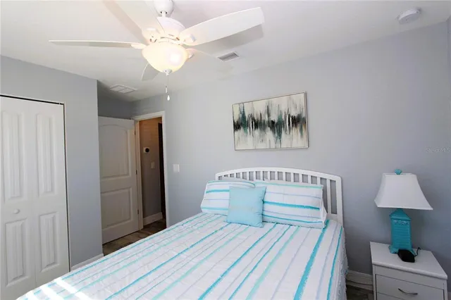 a bedroom with a bed and a lamp on table