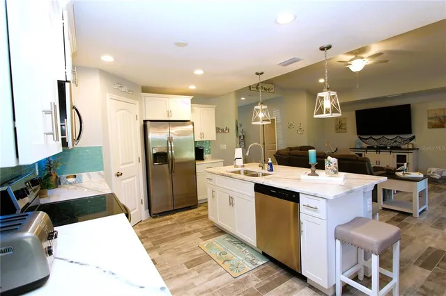 a large kitchen with a large counter top appliances and cabinets