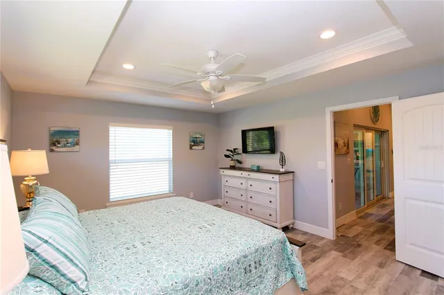 a bedroom with a large bed and a chandelier