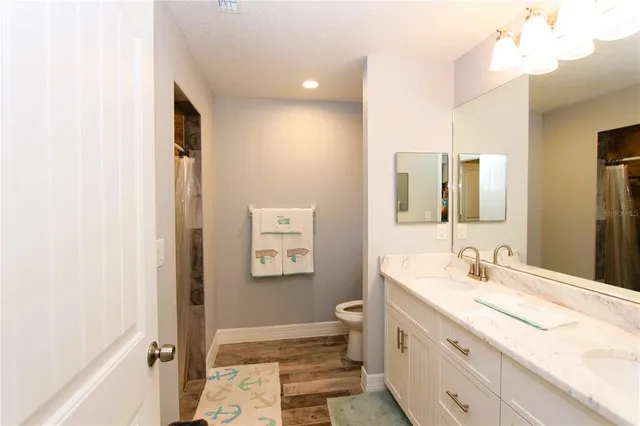 a bathroom with a double vanity sink and mirror