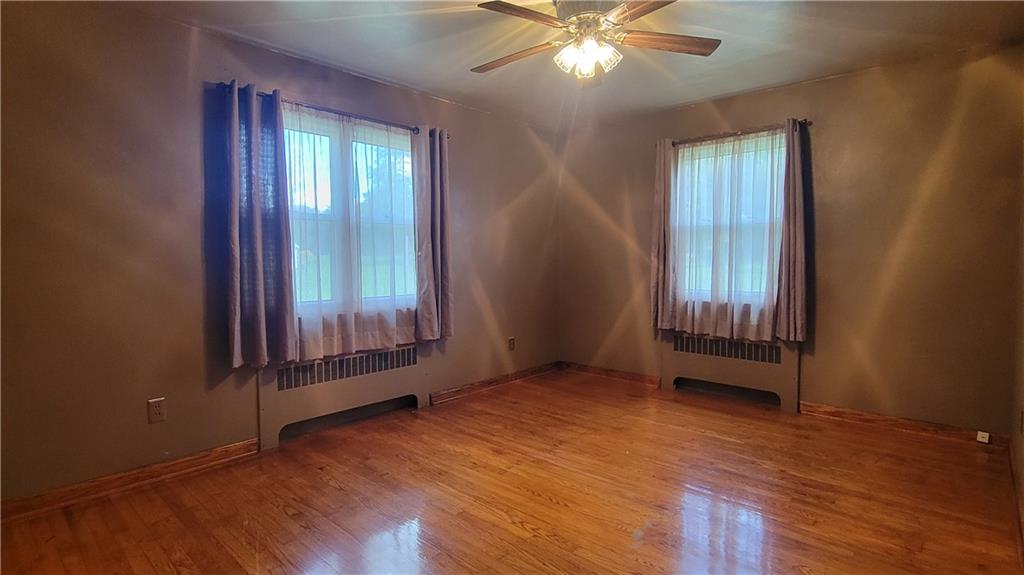 1245 Blacks Hill Road Boswell, PA 15531 - Photo 16 of 48 an empty room with wooden floor and windows