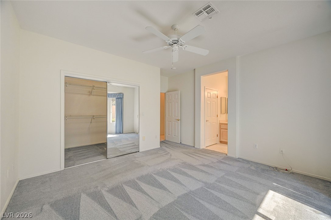 2529 Springville Way Henderson, NV 89052 - Photo 33 of 70 Plush carpeting anchors this spacious bedroom featuring direct access to an en suite bath.